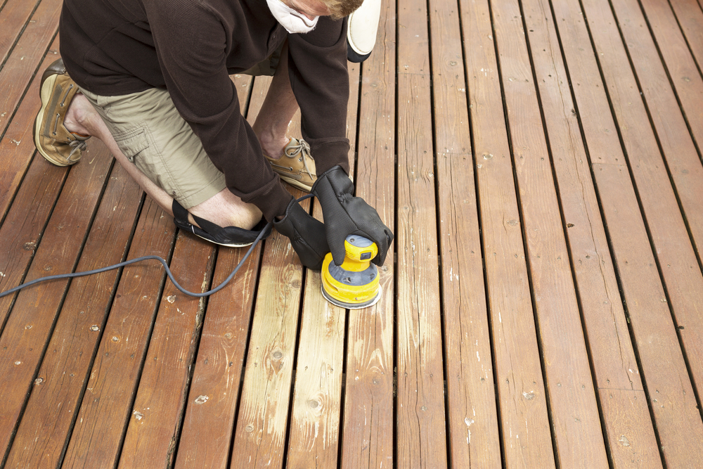 Man performing maintenance on a deck