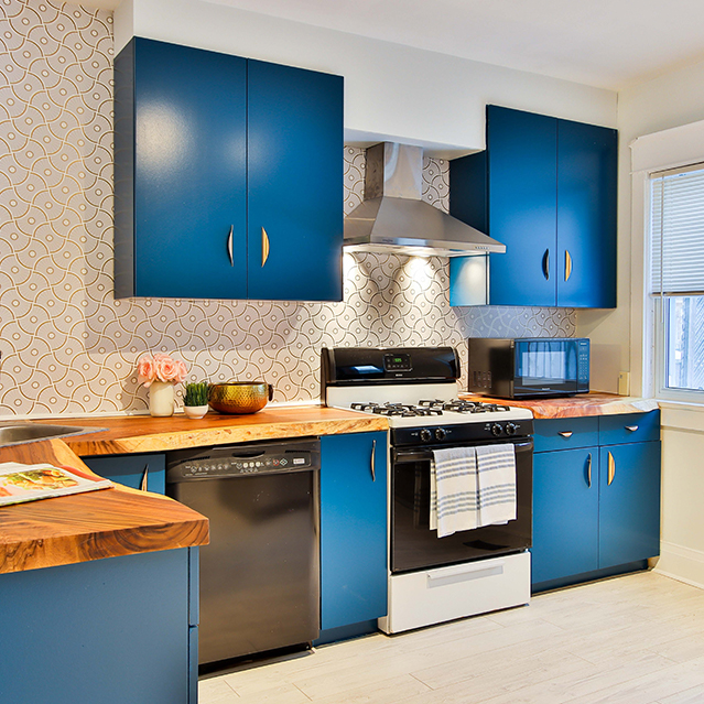 Blue kitchen with butcher block countertops