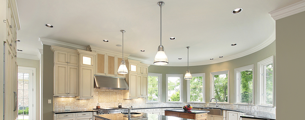 Recessed and hanging light fixtures in kitchen