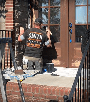 Man painting a door