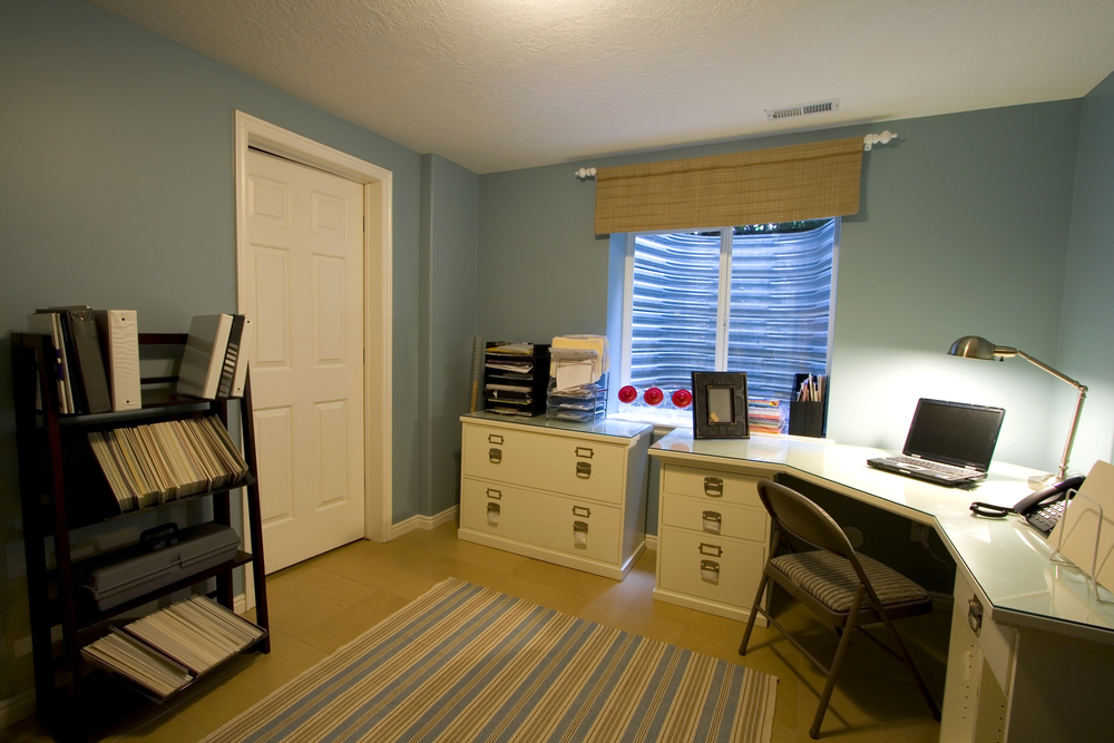 a home office with a thick wooden door