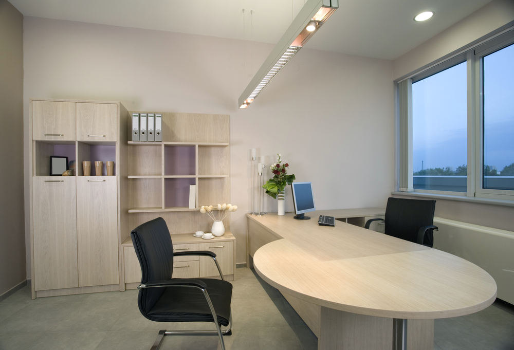 a home office with lighting installed above the desk