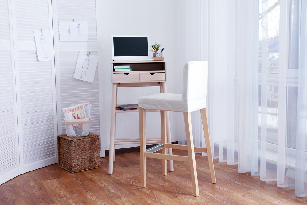 a small home office space with a portable desk
