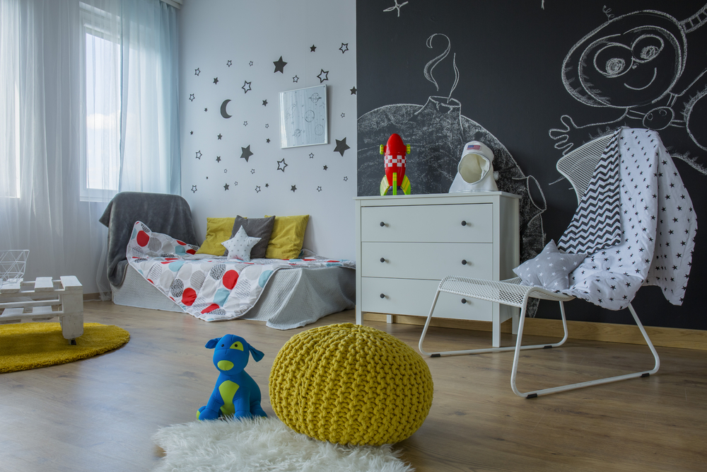 a child’s bedroom with a large blackboard built into one wall