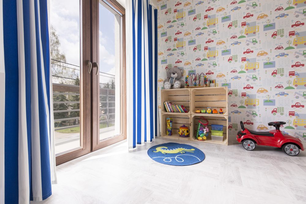 a child’s bedroom with car wallpaper