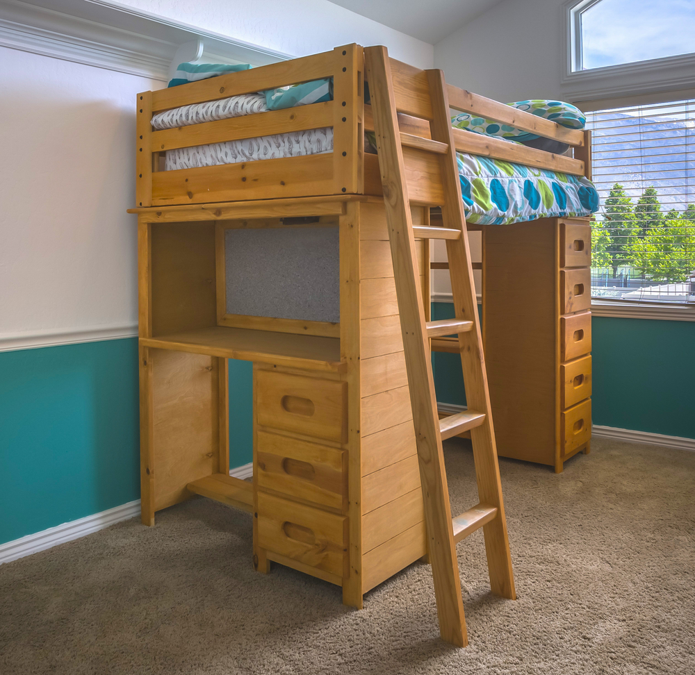 a wooden bunk bed with shelves and drawers built in