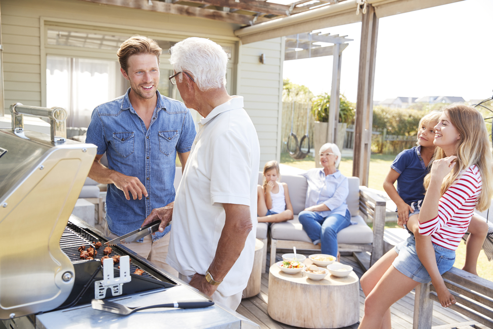a family enjoying a cookout on a backyard deck