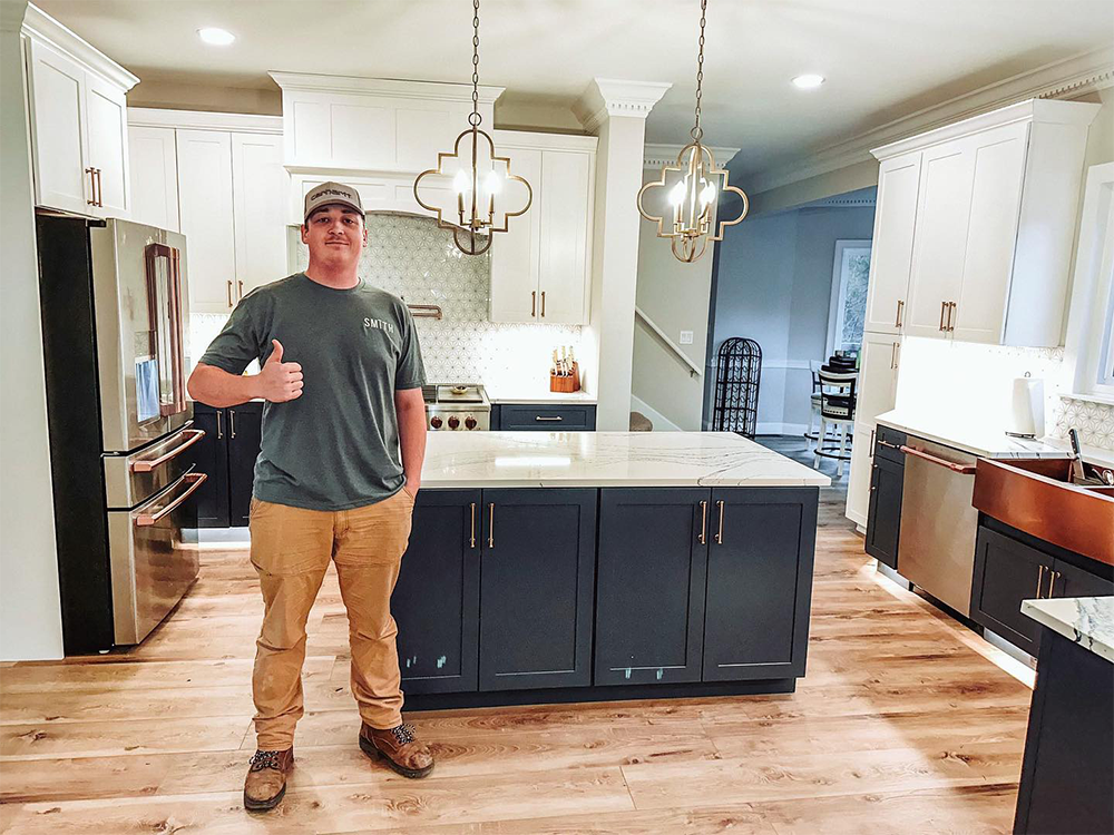 Handyman giving thumbs up in renovated kitchen