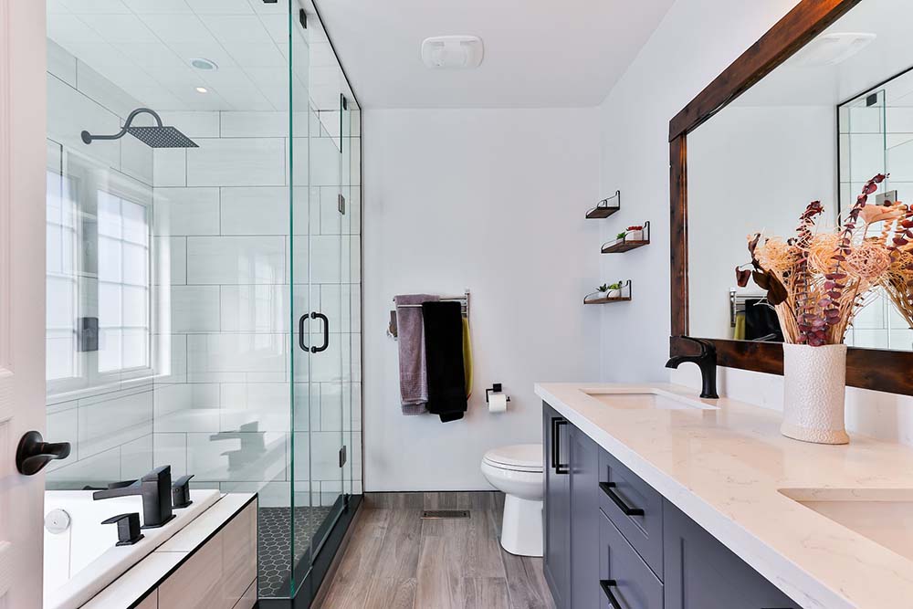 A clean bathroom with a stall shower, double-wide vanity, and white toilet.