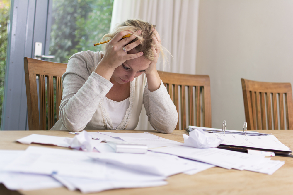 Woman frustrated looking through finances