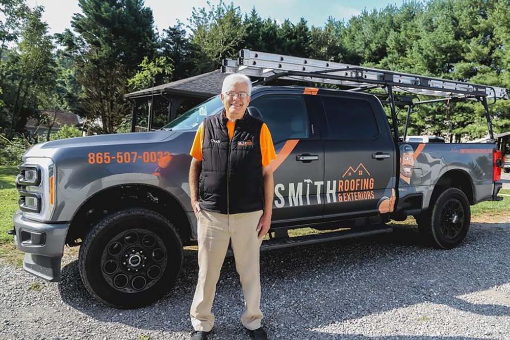 Smith Handyman’s Fleet Manager, Chuck, standing in front of a company truck.